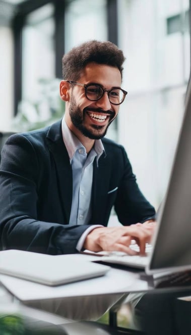 business man typing on computer smiling business man typing on computer smiling